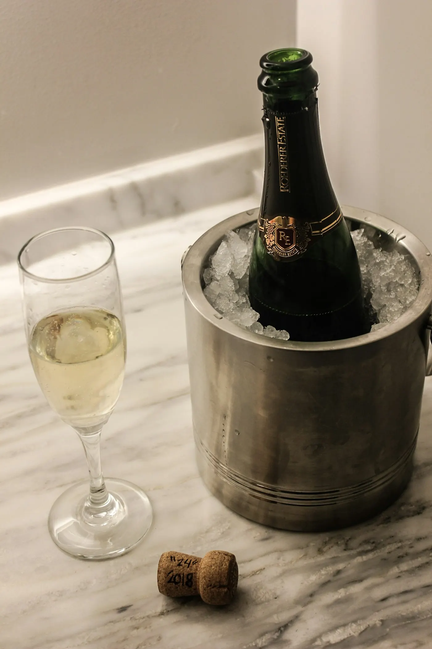 Bouteille de champagne dans un seau à glace et flûtes